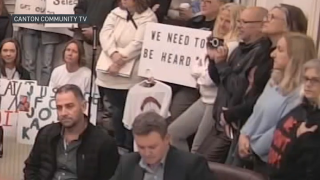 People at a public meeting of the Canton Select Board on Tuesday, Sept. 26, 2023, some with signs urging public comment be allowed on the Karen Read case.