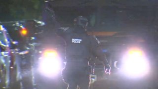 A member of a Boston police SWAT team at a standoff in Dorchester early Tuesday, Sept. 26, 2023.