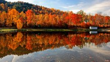 Brilliant New England foliage along a small pond in New Hampshire White Mountains National Forest