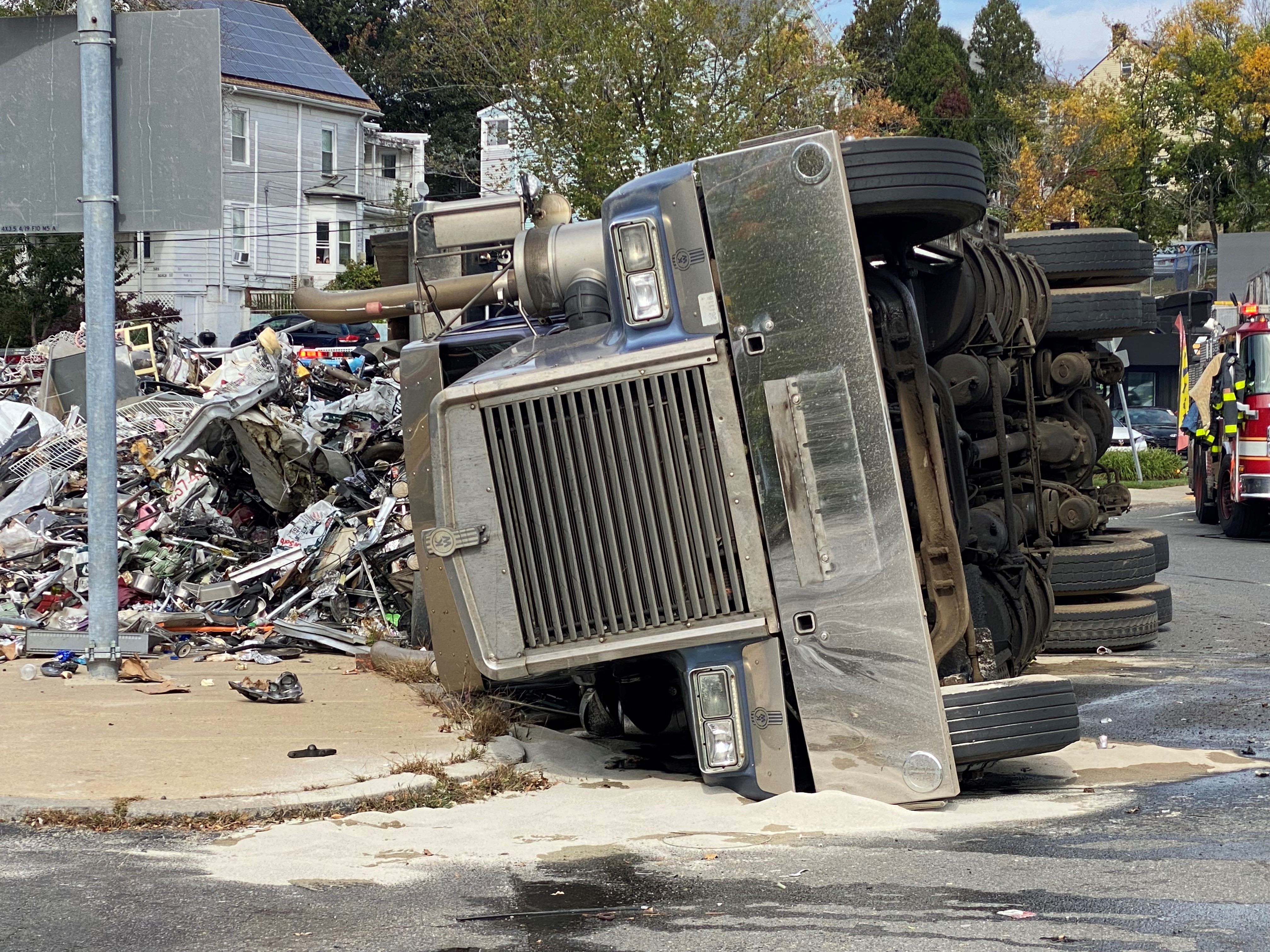 A rolled-over truck that spilled trash or scrap in Revere, Massachusetts, on Tuesday, Oct. 10, 2023.