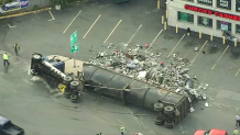 A rolled-over truck that spilled trash or scrap in Revere, Massachusetts, on Tuesday, Oct. 10, 2023.