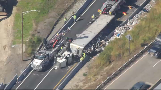 A truck rolled over as it was exiting the Massachusetts Turnpike eastbound onto I-495, spilling trash that closed the ramp, on Wednesday, Oct. 4, 2023.