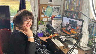 Maria Martin at her desk with radio production equipment at her home in Guatemala.