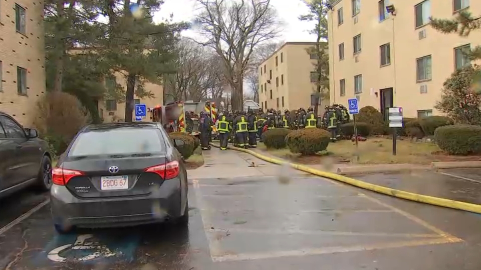 Boston firefighters at the scene of a standoff in the city's Mattapan neighborhood on Saturday, Dec. 30, 2023.