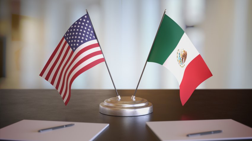 USA and Mexican flags on table. Negotiation between Mexico and United states. 3D rendered illustration.