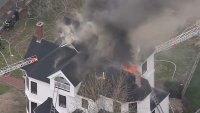 Fire burning at large home in Newton