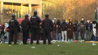 Police and protesters face each other at a pro-Palestinian encampment at Northeastern University on Saturday, April 27, 2024.