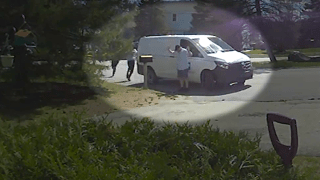 A U.S. postal worker being robbed at gunpoint in Nashua, New Hampshire, on Tuesday, April 16, 2024.