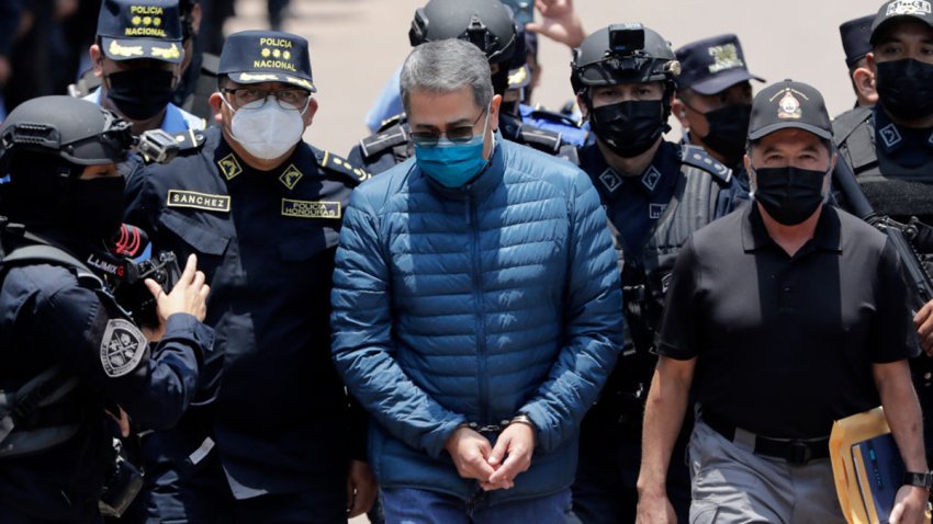 TEGUCIGALPA, HONDURAS – APRIL 21: Former President  of Honduras Juan Orlando Hernandez is escorted  by Members of the Police Special Forces to be extradited to U.S.to face charges of taking bribes from drug traffickers at Honduran National Directorate of Special Forces on April 21, 2022 in Tegucigalpa, Honduras. Hernandez will stand trial for allegedly aiding the smuggling of hundreds of tons of cocaine to America (Photo by Jorge Cabrera/Getty Images)