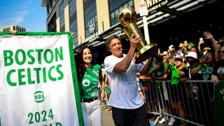 Boston Celtics owner Wyc Grousbeck holds the Larry O'Brien Championship Trophy during the Celtics' championship parade on June 21, 2024 following their 2024 NBA Finals win.