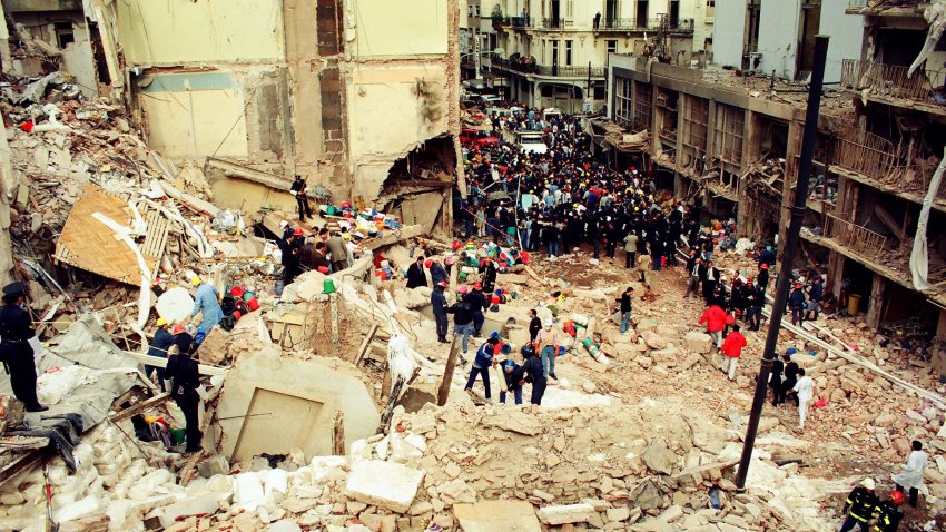 Rescue workers sift through the rubble at the site of a car-bombing at the Asociacion Mutual Israelita Argentina (AMIA) Jewish Community Center in Buenos Aires, Argentina, on July 18, 1994. Sirens will sound across Argentina on July 18, 2007, as the nation marks the anniversary of the biggest attack on a Jewish community outside Israel since World War II. The bombing, which remains unsolved, killed 85 people and injured 300. Photographer: Diego Levy/Bloomberg via Getty Images