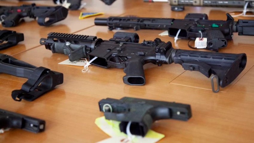 Ghost guns and ghost gun parts are displayed on a table in Attorney General Andrea Campbell’s office at a press event she hosted on July 11, 2023.