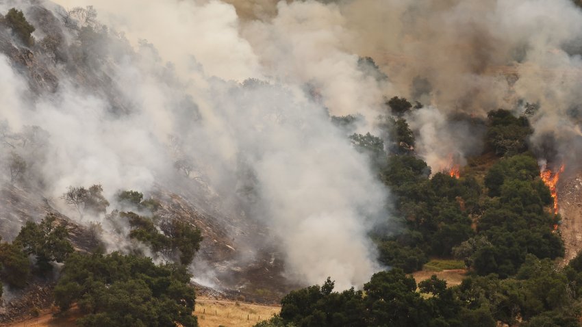 LOS OLIVOS, CALIFORNIA – JULY 06: ‘Hotshot’ firefighters (LOWER L) work to contain the Lake Fire burning in Los Padres National Forest with evacuation warnings in the area on July 6, 2024 near Los Olivos, California. The wildfire in Santa Barbara County has scorched over 13,000 acres amid a long-duration heat wave which is impacting much of California. (Photo by Mario Tama/Getty Images)