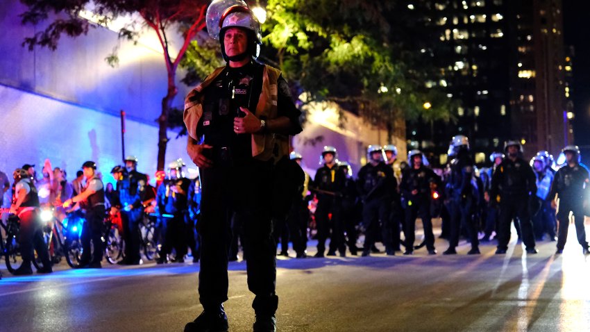 CHICAGO, ILLINOIS – AUGUST 20: Police line up amid a protest at the Israeli consulate during the Democratic National Convention on August 20, 2024 in Chicago, Illinois.   Protestors are rallying in Chicago while the DNC is in session August 19-22. (Photo by Jim Vondruska/Getty Images)