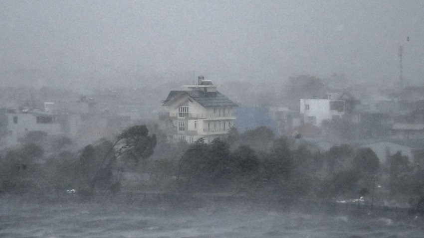 TOPSHOT – Water is whipped up by high winds onto the shore of Phuong Luu lake as Super Typhoon Yagi hits Hai Phong on September 7, 2024. Super Typhoon Yagi uprooted thousands of trees and swept ships and boats out to sea as it made landfall in northern Vietnam on September 7, state media said. (Photo by NHAC NGUYEN / AFP) (Photo by NHAC NGUYEN/AFP via Getty Images)