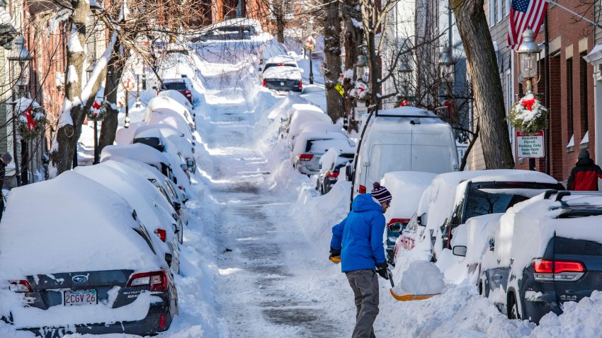 TOPSHOT – A person shovels snow in Boston, Massachusetts, on January 30, 2022. – Blinding snow whipped up by powerful winds pummeled the eastern United States into the early hours of January 30, as one of the strongest winter storms in years triggered transport chaos and power outages across a region of some 70 million people. (Photo by JOSEPH PREZIOSO / AFP) (Photo by JOSEPH PREZIOSO/AFP via Getty Images)