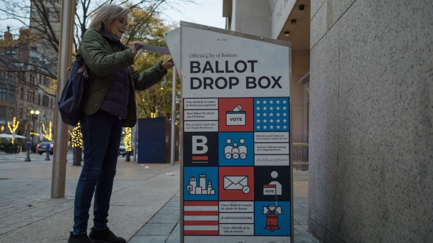 A voter drops a ballot in a drop box outside the Boston Public Library on Tuesday, Nov. 5, 2024.