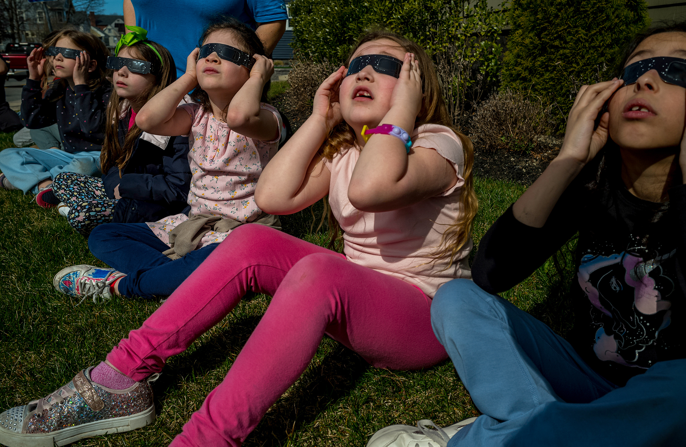 April 8, 2024: Students at For Kids Only Afterschool program view the solar eclipse from a patch of grass in Winthrop.