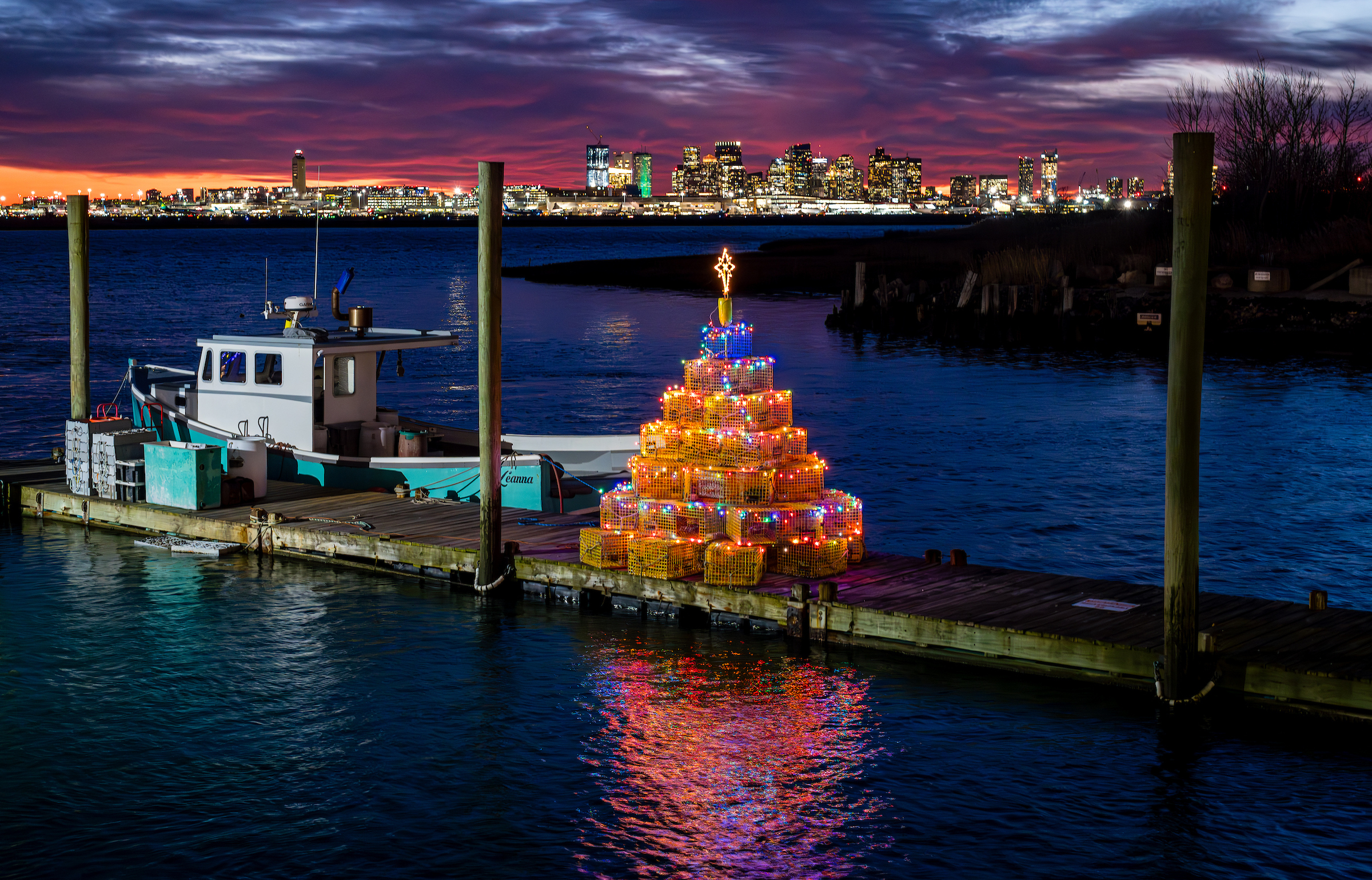 Dec. 6, 2024: The Boston sunset is framed by a lobster trap Christmas Tree in the Belle Isle section of Winthrop, along the Boston city line.