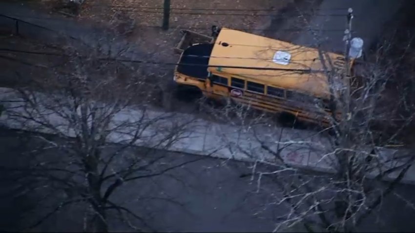 A school bus on a sidewalk by the Mary Curley School in Boston's Jamaica Plain neighborhood on Friday, Dec. 6, 2024.