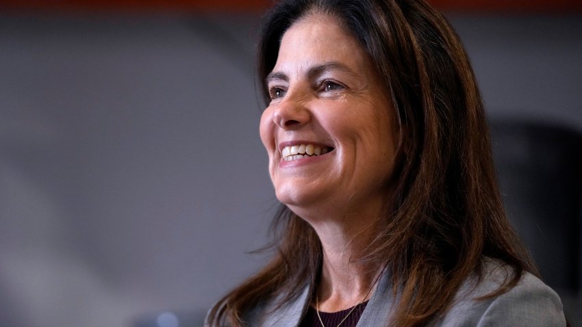 Then Republican gubernatorial candidate Kelly Ayotte, smiles during a visit to a local concrete coating business, Wednesday, Oct. 16, 2024, in Manchester, N.H.