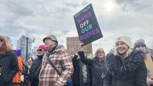 A woman holds a sign at the Boston women's march on Saturday, Jan. 18, 2025.