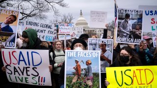 Demonstrators and lawmakers rally against President Donald Trump and his ally Elon Musk as they disrupt the federal government, including dismantling the U.S. Agency for International Development, which administers foreign aid approved by Congress, on Capitol Hill in Washington, Wednesday, Feb. 5, 2025.