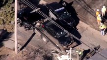 A sedan with heavy front end damage near the MBTA Commuter Rail tracks in Canton, Massachusetts, on Feb. 26, 2025.