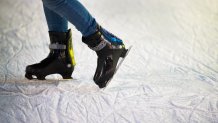 Unrecognizable woman ice skating at night in historical centre of the city of Vienna, Austria. Winter.