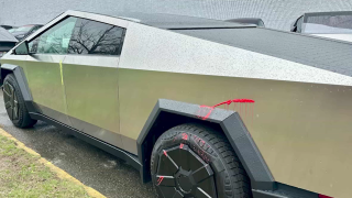 A Tesla Cybertruck that had been defaced with what appears to be yellow and red paint at a dealership in Peabody, Massachusetts, on Tuesday, April 8, 2025.