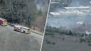 Firefighters responding to an apparent brush fire near Route 3 in Bedford, Massachusetts, on Friday, April 18, 2025.