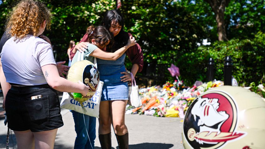 TALLAHASSEE, FLORIDA – APRIL 18: Students visit a makeshift memorial honoring victims of a shooting at Florida State University on April 18, 2025 in Tallahassee, Florida. According to reports, two people were killed and several others injured when the alleged shooter, believed to be a current student and the son of a Leon County sheriff deputy, opened fire on the university main campus on Thursday. (Photo by Miguel J. Rodriguez Carrillo/Getty Images)