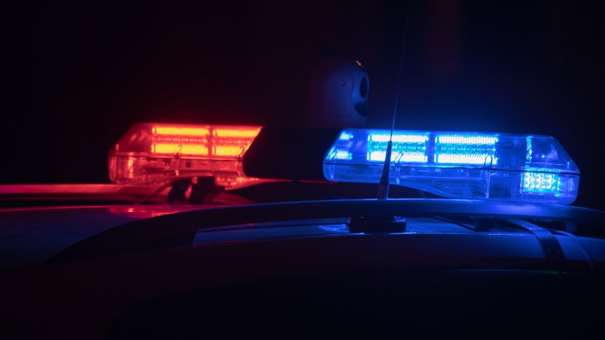 Police car lights at night in city with selective focus and bokeh.