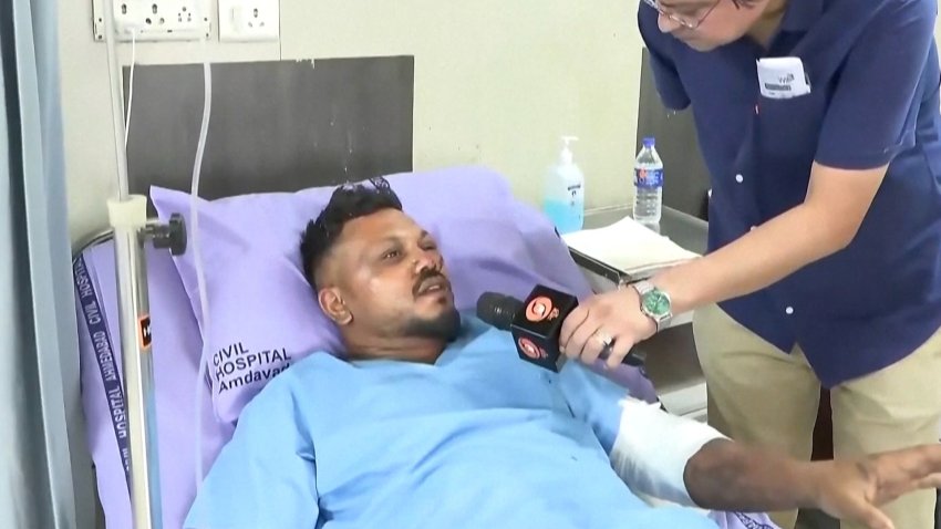 Survivor in hospital bed talking to reporter