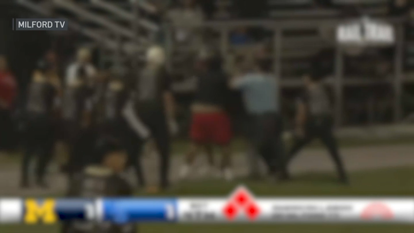 Blurred video of people fighting near the third base line during an American Legion baseball playoff game in Milford, Massachusetts, on Monday, July 21, 2025.