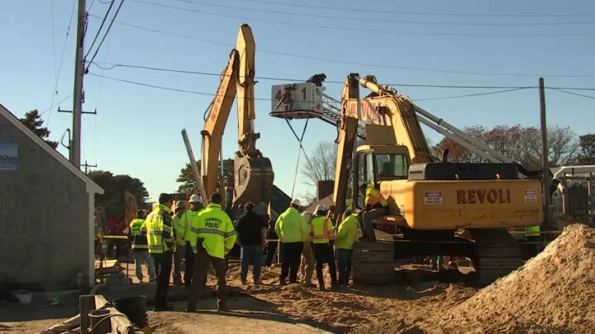 Workers at the scene of a trench collapse that sent at least one person to the hospital in Yarmouth, Massachusetts, on Tuesday, Nov. 18, 2025.