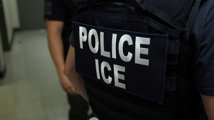 An agent of Immigration and Customs Enforcement (ICE) waits in a hallway outside of a courtroom at New York Federal Plaza Immigration Court inside the Jacob K. Javitz Federal Building in New York on July 17, 2025. US President Donald Trump has made deporting undocumented immigrants a key priority for his second term, after successfully campaigning against an alleged "invasion" by criminals. (Photo by CHARLY TRIBALLEAU / AFP) (Photo by CHARLY TRIBALLEAU/AFP via Getty Images)