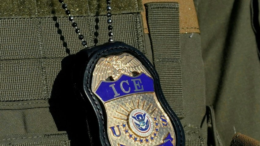 (FILES) File image dated May 7, 2025 in Newark, New Jersey, shows a badge hanging over the uniform of an Immigration and Customs Enforcement (ICE) agent. Natalia fled Russia fearing imminent arrest for her family’s opposition activism and sought political asylum in the United States. But instead of refuge, she found herself locked in jail for over a year, separated from her husband and children and dreading deportation. With the Trump administration stepping up removals as part of its sweeping anti-immigration crackdown, rights activists warn that deporting Russian dissidents puts them at risk of prison and persecution back home. "I supported the opposition, I supported opposition activists who were against (Russian President Vladimir) Putin’s regime," Natalia, 50, told AFP in a phone interview from an immigration detention center in the southern state of Louisiana. "If I return to Russia, I will be arrested." (Photo by TIMOTHY A. CLARY / AFP) (Photo by TIMOTHY A. CLARY/AFP via Getty Images)