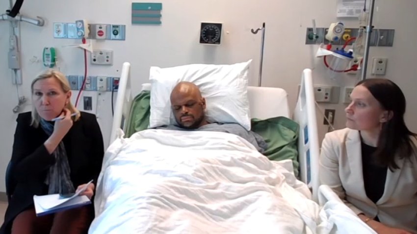Tyler Brown, the accused gunman in a shooting rampage on Memorial Drive in Cambridge, in his hospital bed ahead of his arraignment.