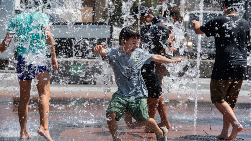 Kids cool off at a splash pad at the Rose Kennedy Greenway as temperatures soar into the high 90 degrees Fahrenheit (high 30s Celsius) in Boston, Massachusetts on July 29, 2025. According to the US National Weather Service, the Boston area is under a heat advisory through the evening of July 30. (Photo by Joseph Prezioso / AFP) (Photo by JOSEPH PREZIOSO/AFP via Getty Images)