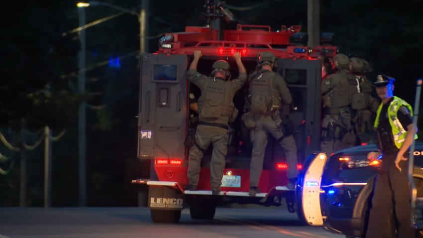 Police officers on a SWAT vehicle headed to an incident in Mansfield, Massachusetts, on Monday, July 27, 2026.