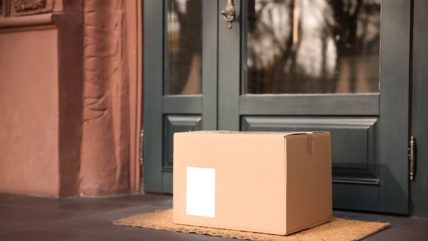 Delivered parcel on door mat near entrance