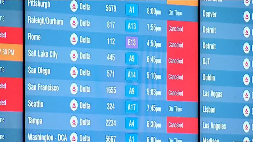 Logan Airport flight board on Sunday.