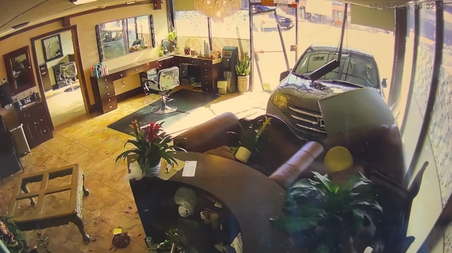 A still from surveillance video showing a car partially inside a Peabody, Massachusetts, nail salon on Tuesday, Oct. 6, 2026.